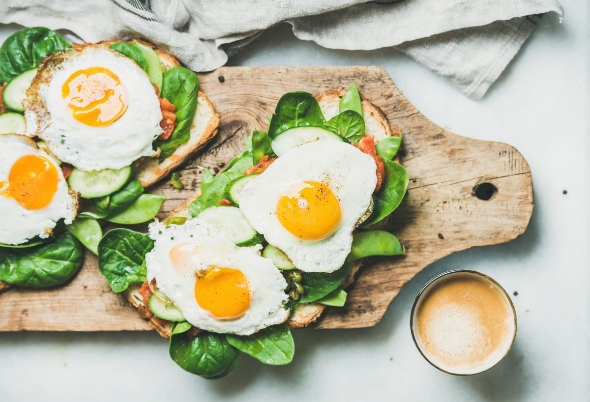 Breakfast toast with sunny-side-up eggs and lots of greens