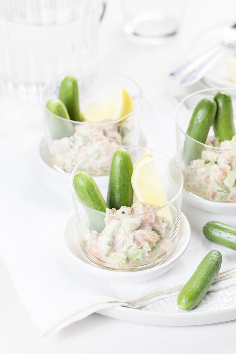 Appetizer of avocado salmon salad and snack cucumber