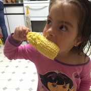 girl eating corn