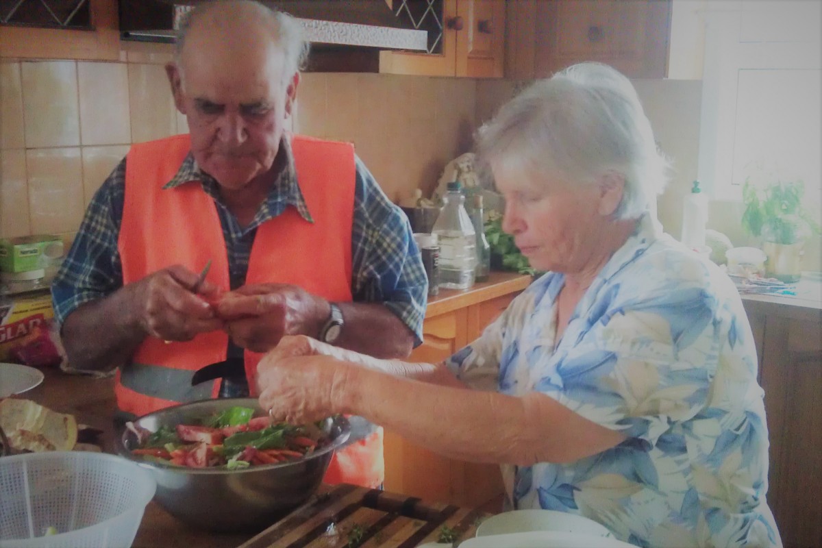 Preparing a Maltese garden salad with fresh vegetables 