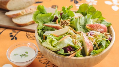 Colorful salad mix with pears, walnuts and Parmesan