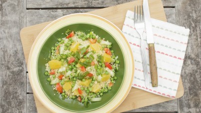 Couscous salad with green peas, capsicum, orange and mint