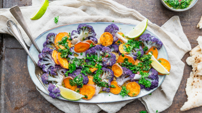 Traybake with cauliflower, sweet potatoes and green herb oil 