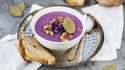 Red cabbage soup topped with apple and walnut 