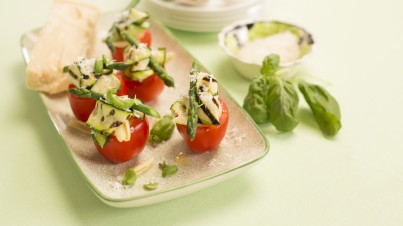 Stuffed tomatoes with pasta, green asparagus and Parmesan cheese
