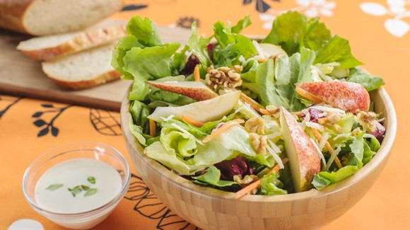 Colorful salad mix with pears, walnuts and Parmesan