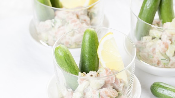 Appetizer of avocado salmon salad and snack cucumber